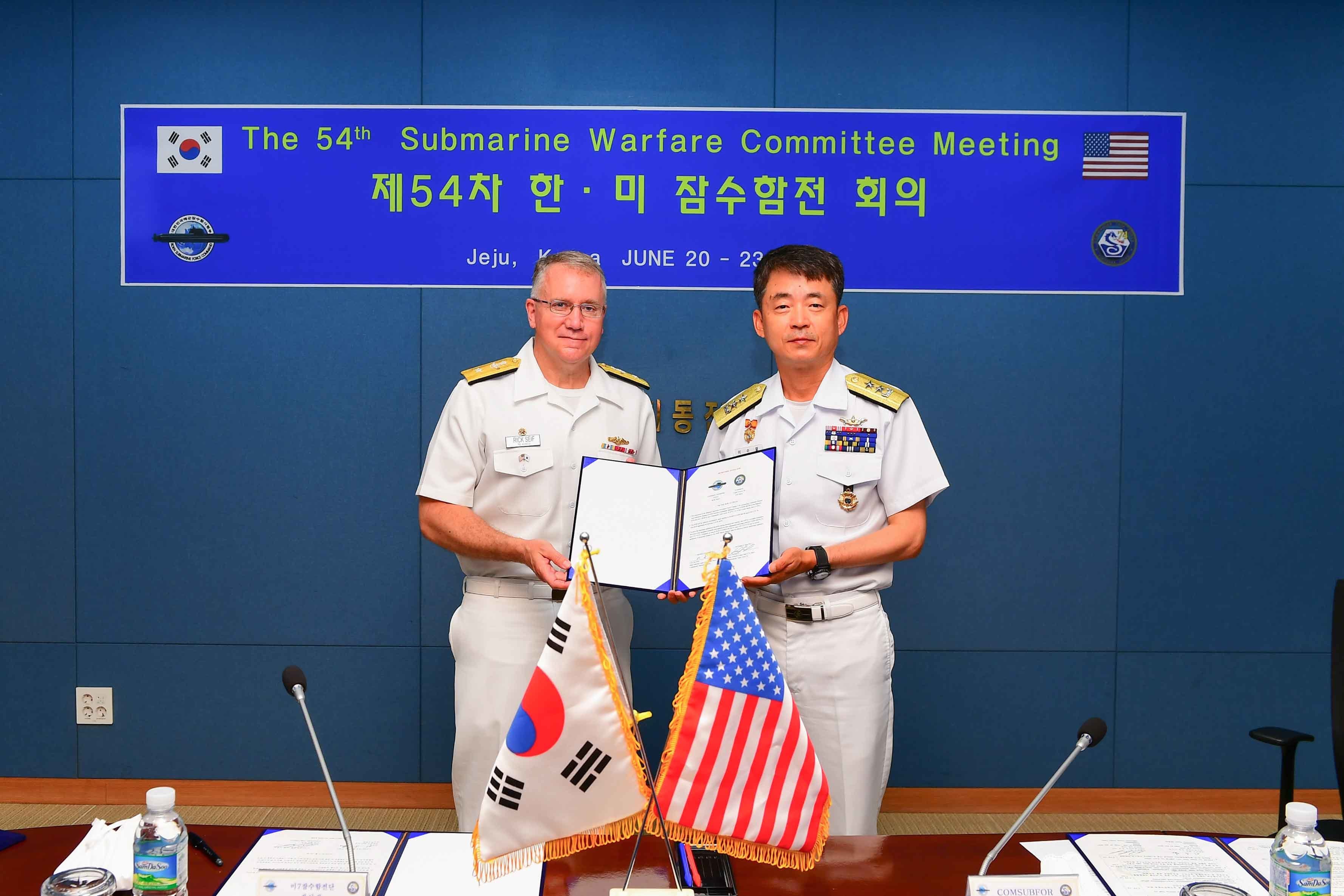 JEJU, Republic of Korea (June 22, 2022) Rear Adm. Rick Seif, Commander, Submarine Group 7, left, and Rear Adm. Lee Su Youl, Commander, Republic of Korea (ROK) Navy Submarine Force, pose with the signed memorandum at the conclusion of the 54th semiannual Submarine Warfare Committee Meeting (SWCM) in Jeju, South Korea, June 22, 2022. Over the past 28 years, SWCM has brought together leaders of both the U.S. and ROK submarine forces to discuss combined submarine training and force integration. (Photo courtesy of ROK Public Affairs)