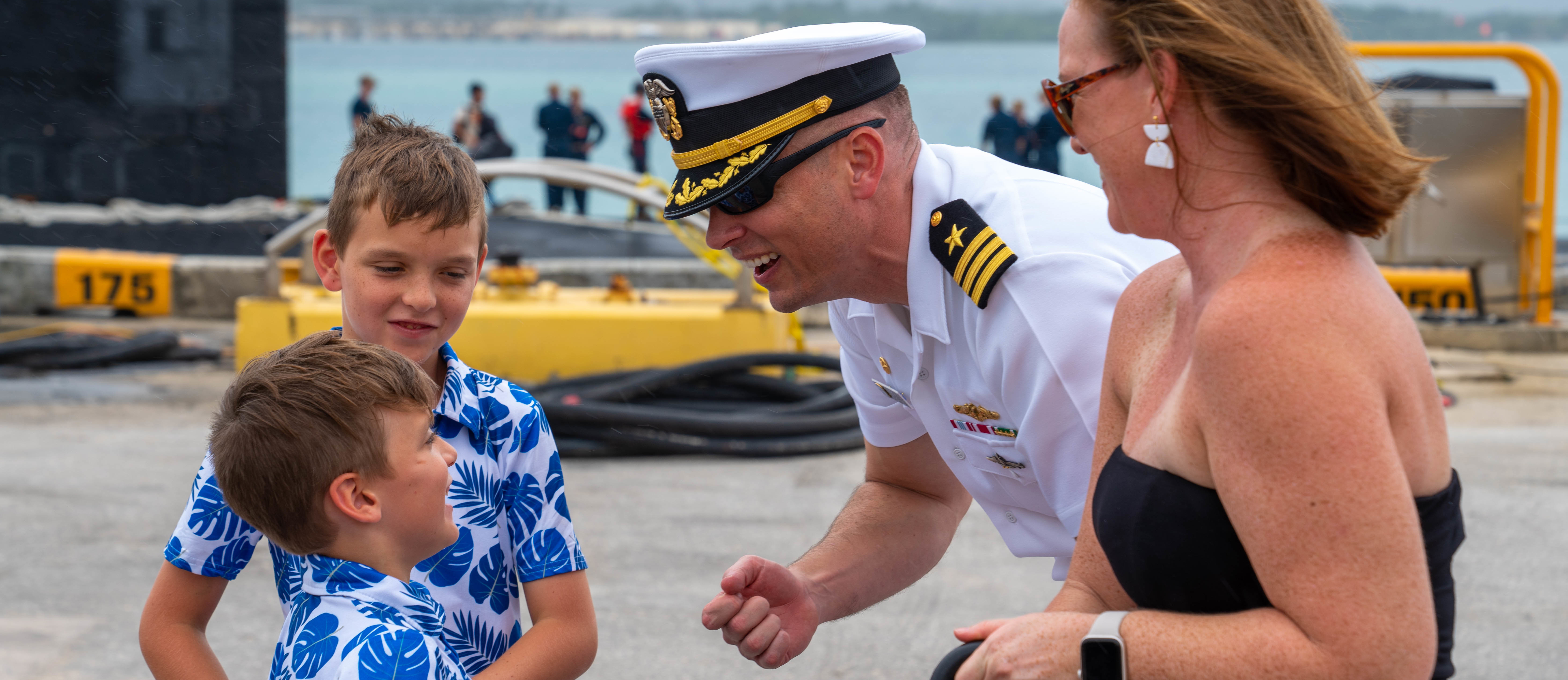 POLARIS POINT, Guam (Jan. 9, 2023) Cmdr. Andrew Domina, commanding officer of the Los Angeles-class fast-attack submarine USS Springfield (SSN 761), greets his family after Springfield’s return to Guam from deployment, Jan. 9. Springfield is capable of supporting various missions, including anti-submarine warfare, anti-ship warfare, strike warfare and intelligence, surveillance reconnaissance. (U.S. Navy photo by Lt. Eric Uhden)