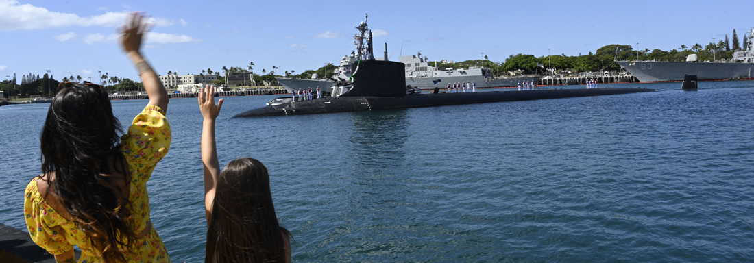 230727-N-SS492-1025 PEARL HARBOR (July 27, 2023) Family members greet the Virginia-class fast-attack submarine USS Vermont (SSN 792) as it arrives at its new homeport of Joint Base Pearl Harbor-Hickam, July 27, 2023. Vermont, the first Block IV Virginia-class submarine to enter service, is a new construction submarine that is joining the six Virginia-class submarines already assigned to Commander, Submarine Squadron (CSS) 1. (U.S. Navy photo/video by Chief Mass Communication Specialist Amy Biller)