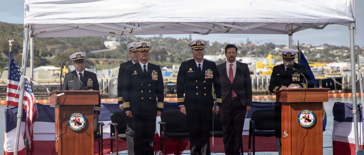 NAVAL BASE POINT LOMA, Calif. (Feb. 17, 2026) Capt. Phillip Sylvia, left, commander, Submarine Squadron 11, stands with Cmdr. Chad Tella, off-going commanding officer, Los Angeles-class fast-attack submarine USS Greeneville (SSN 772), during the change of command ceremony for Greeneville onboard Naval Base Point Loma, Feb. 17, 2026. During the ceremony, Tella was relieved by Cmdr. Spencer Ovren as commanding officer of Greeneville. Greeneville is assigned to Commander, Submarine Squadron 11, home to four Los Angeles-class fast-attack submarines, which are capable of supporting various missions, including anti-submarine warfare, anti-ship warfare, strike warfare and intelligence, surveillance and reconnaissance. (U.S. Navy photo by Mass Communication Specialist 1st Class Tiarra Brown)