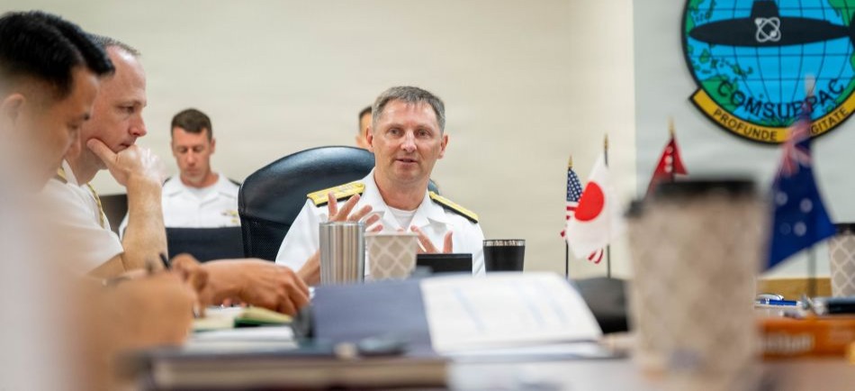 JOINT BASE PEARL HARBOR-HICKAM (April 8, 2026) — Rear Adm. Chris Cavanaugh, center, commander, Submarine Force, U.S. Pacific Fleet, provides opening remarks to various leaders during the 2026 Undersea Warfare Commanders’ Conference (USWCC) at Joint Base Pearl Harbor-Hickam, Hawaii, April 8, 2026. First held in 2018, this year’s conference theme was “Shaping the future: Moving forward quickly and collaboratively to assure our combined advantage in the undersea domain.” The USWCC conference included submarine force representatives from Australia, Canada, France, Japan, Republic of Korea, and Singapore. The multi-day event included briefings from each partner nation focused on force employment, combat readiness, interoperability, and integration of emerging technology such as unmanned systems and artificial intelligence. (U.S. Navy photo by Chief Mass Communication Specialist Omar A. Dominquez)
