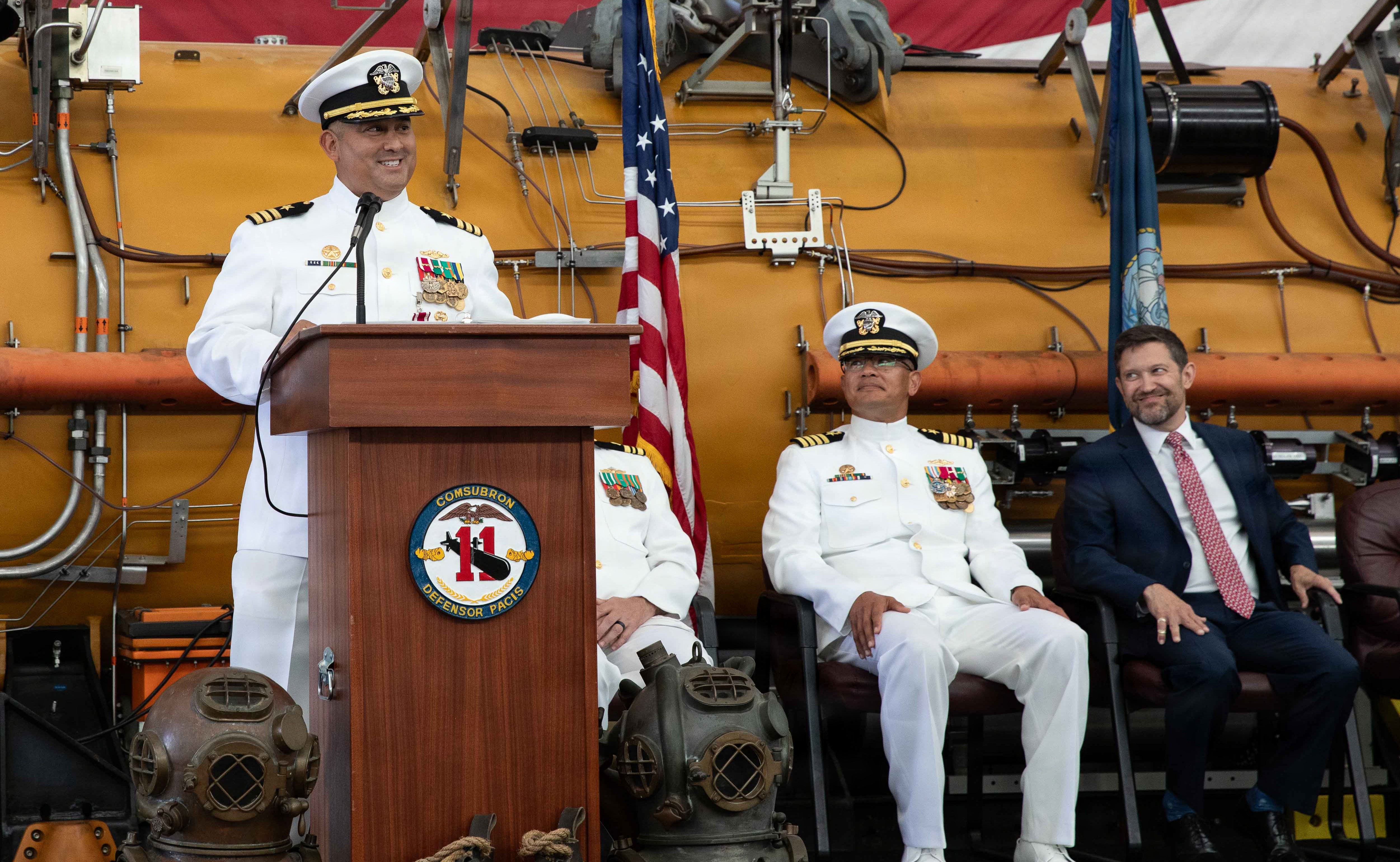 NAVAL AIR STATION NORTH ISLAND, Calif. (June 26, 2026) Cmdr. Christian Rivera, off-going commanding officer, Undersea Rescue Command (URC), speaks during the change of command ceremony for URC onboard Naval Air Station North Island, June 26, 2026. During the ceremony, Rivera was relieved by Cmdr. Michael Mowry as commanding officer of URC. URC, comprised of active and Reserve component Sailors, and civilian contractors, is the Navy’s only submarine rescue-capable command ready to deploy around the world in the event of a submarine emergency. (U.S. Navy photo by Mass Communication Specialist 2nd Class Rashan Jefferson)