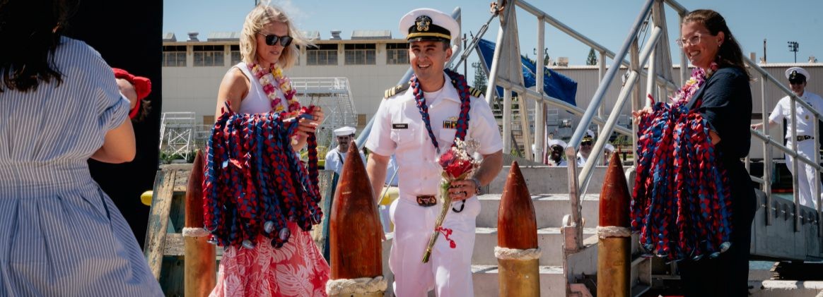 JOINT BASE PEARL HARBOR-HICKAM, Hawaii (August 27, 2026) - A Sailor assigned to Virginia-class fast-attack submarine USS Montana (SSN 794), greets his family as Montana returns to Joint Base Pearl Harbor-Hickam from deployment, August 27, 2026. Montana is assigned to Submarine Squadron 1 and is capable of supporting various missions, including anti-submarine warfare, anti-surface ship warfare, strike warfare, and intelligence, surveillance, and reconnaissance (U.S. Navy photo by Sonar Technician 3rd Class Cannen Tukes).
