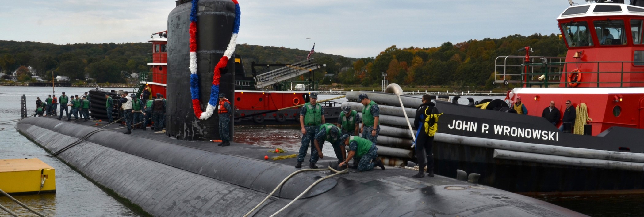 Sailors, assigned to the Los Angeles-class attack submarine USS Toledo (SSN 769), heave around the first mooring line as their boat is held in position by two supporting tugboats. Toledo returned from a seven-month deployment in the 6th fleet area of operations. The U.S. Navy has a 237-year heritage of defending freedom and projecting and protecting U.S. interests around the globe. (U.S. Navy photo by Mass Communication Specialist 1st Class Jason J. Perry/Released)